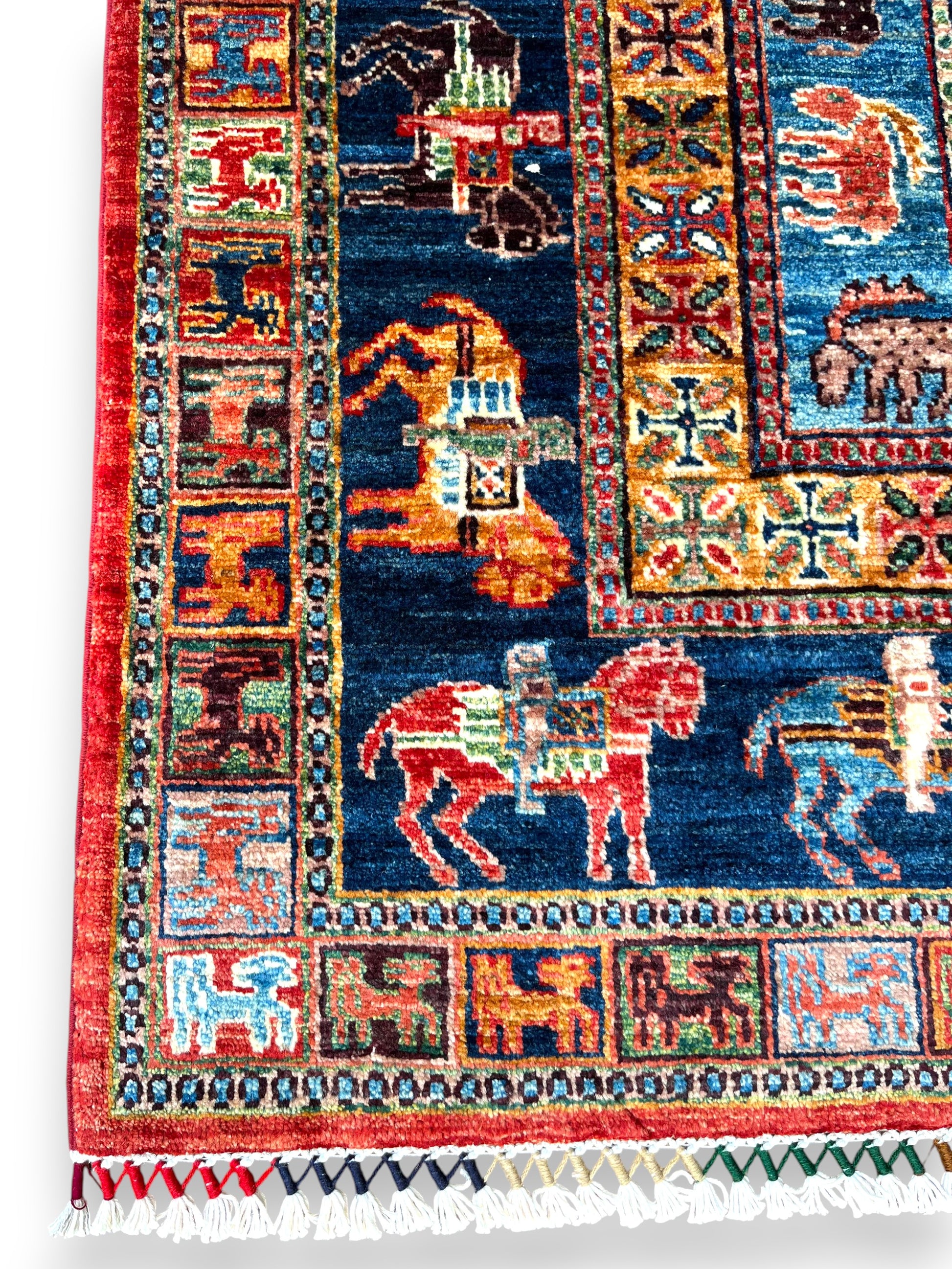 Close-up detail of Afghan pictorial rug showing intricate geometric medallion patterns in burgundy center field with precise hand-knotted wool craftsmanship