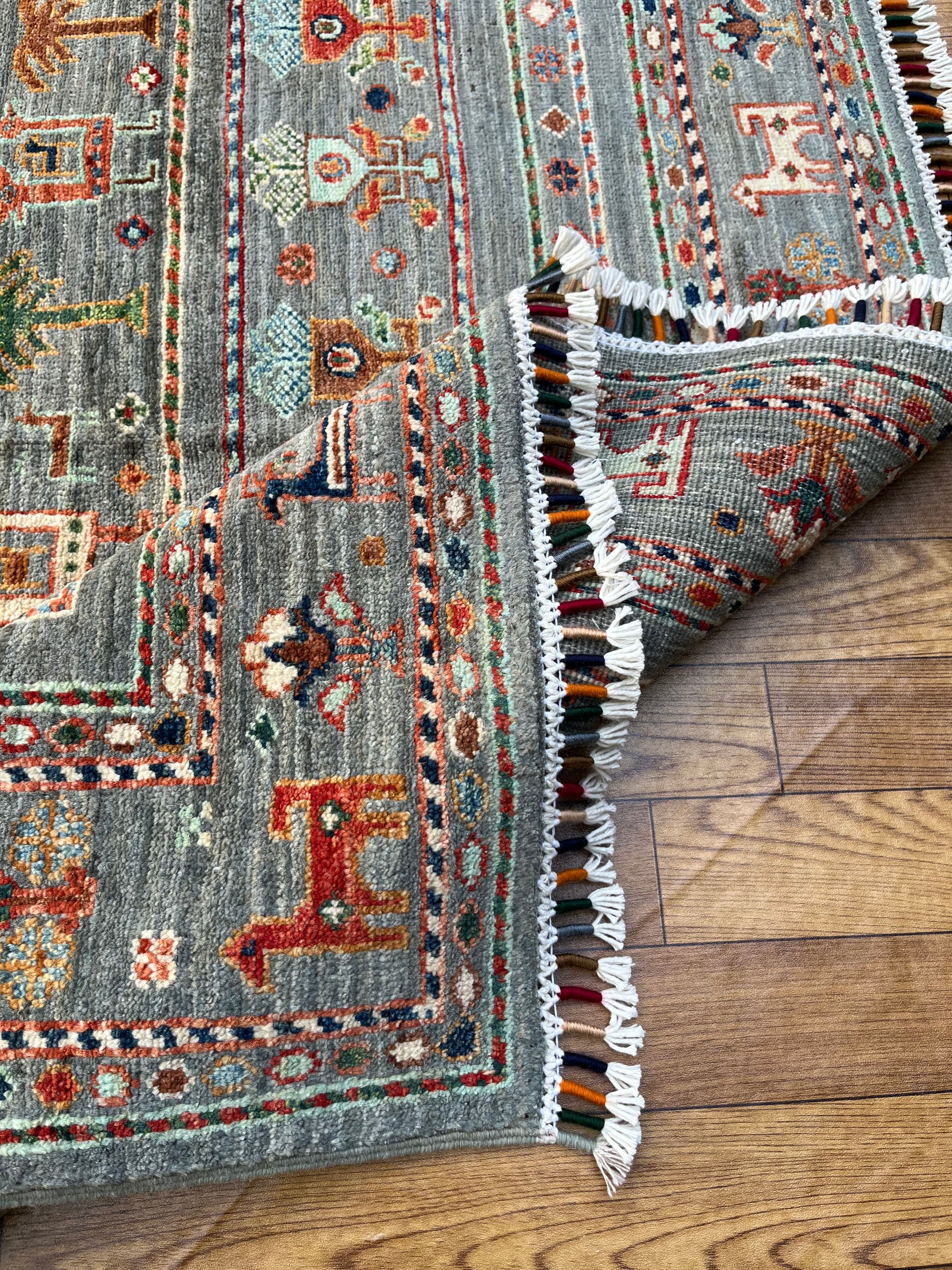Hand-knotted Afghan rug corner showing cotton fringe detail and quality wool construction