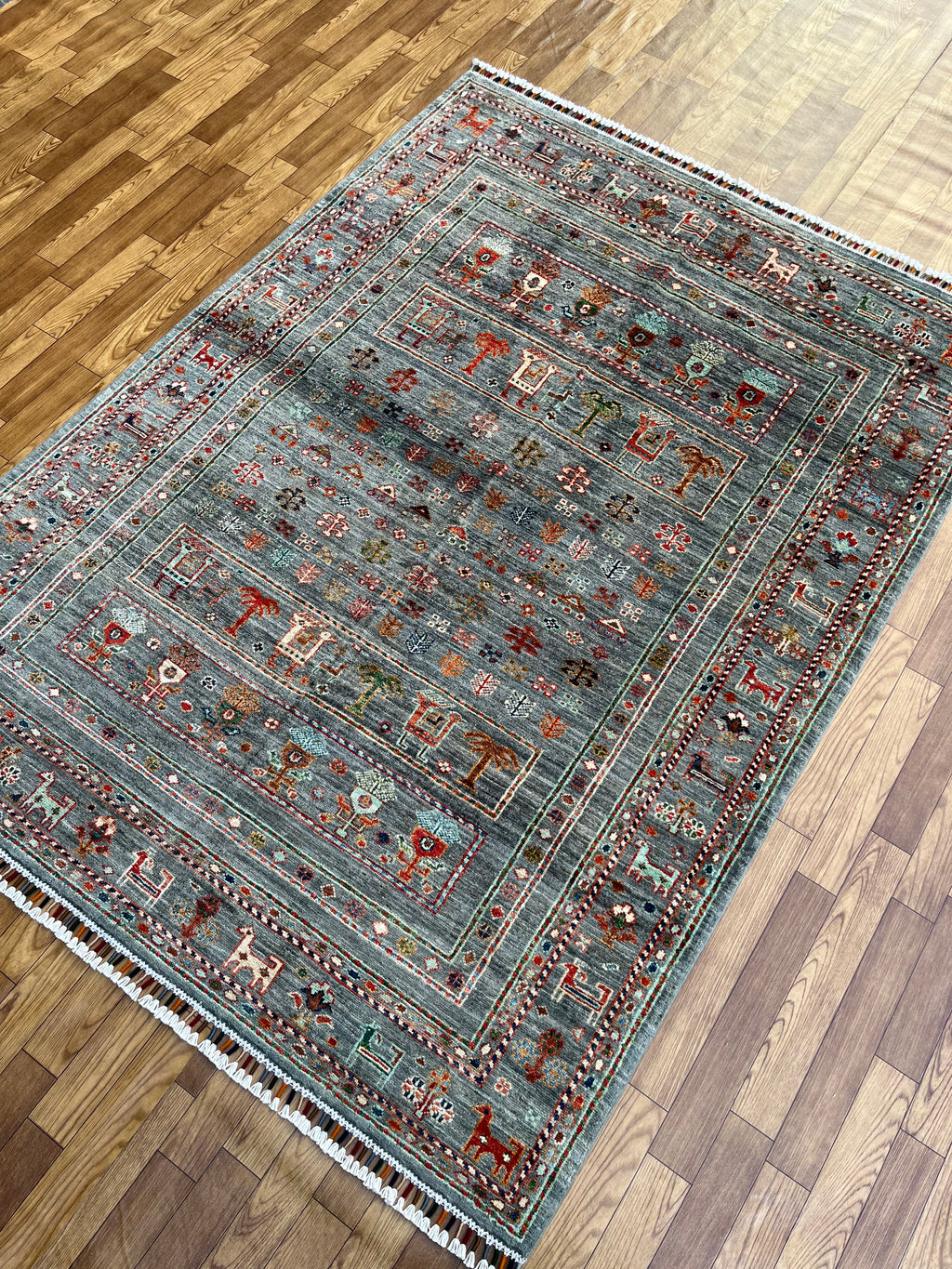 Large blue grey Afghan hand-knotted area rug 118x59 inches displayed in modern living room setting