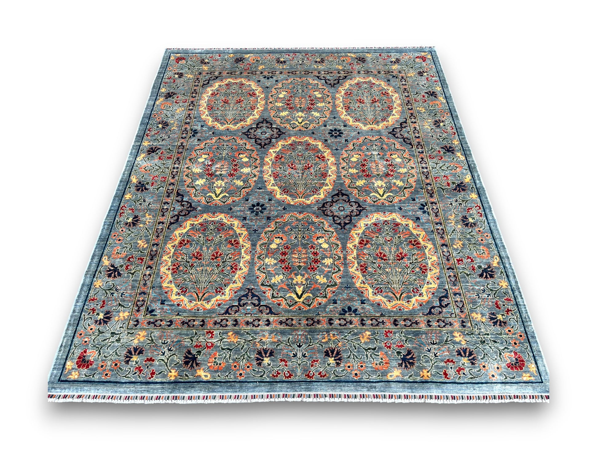 Large blue Afghan ornament rug displayed in elegant room setting showing circular medallion pattern