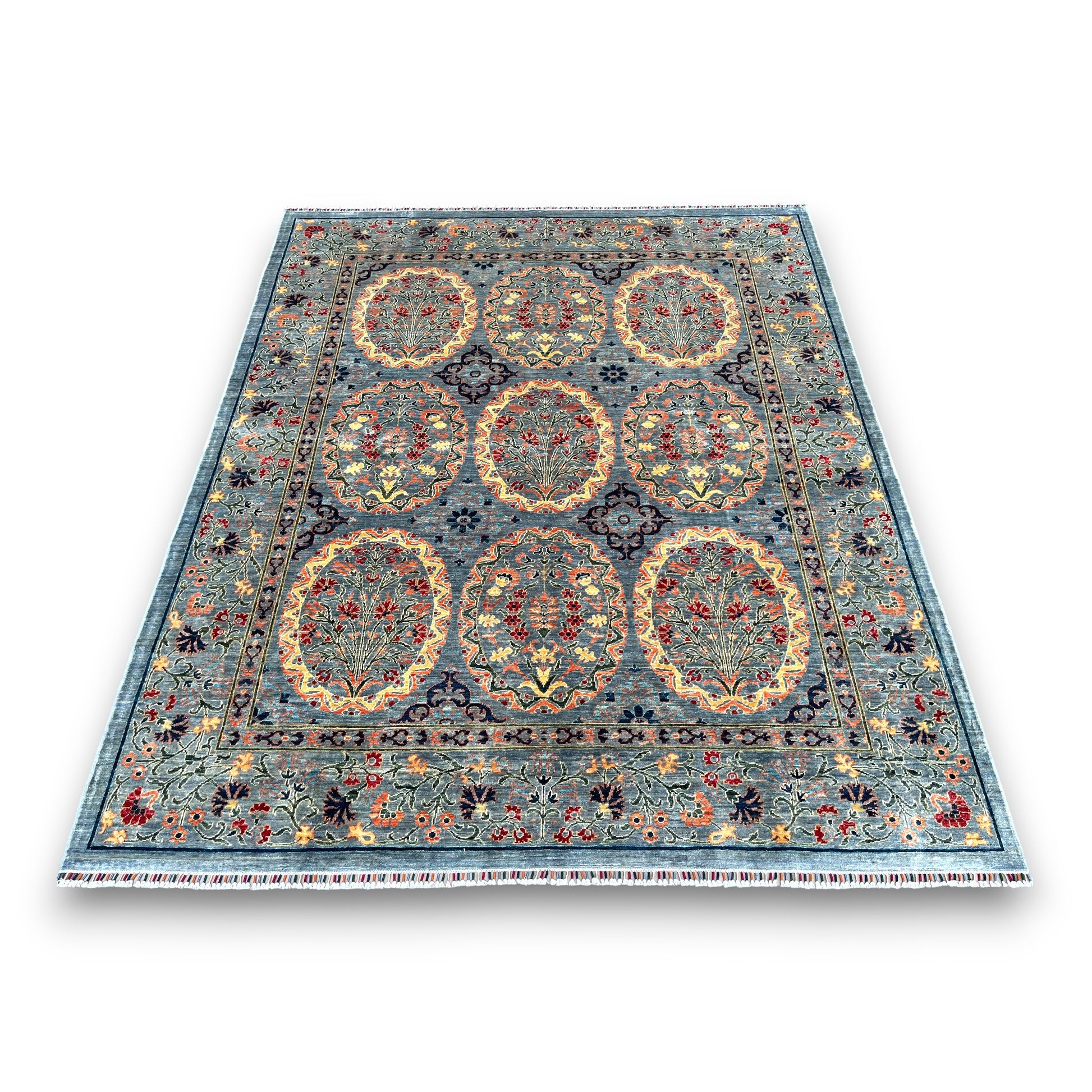 Blue Afghan ornament rug with nine circular medallions containing floral motifs on white background