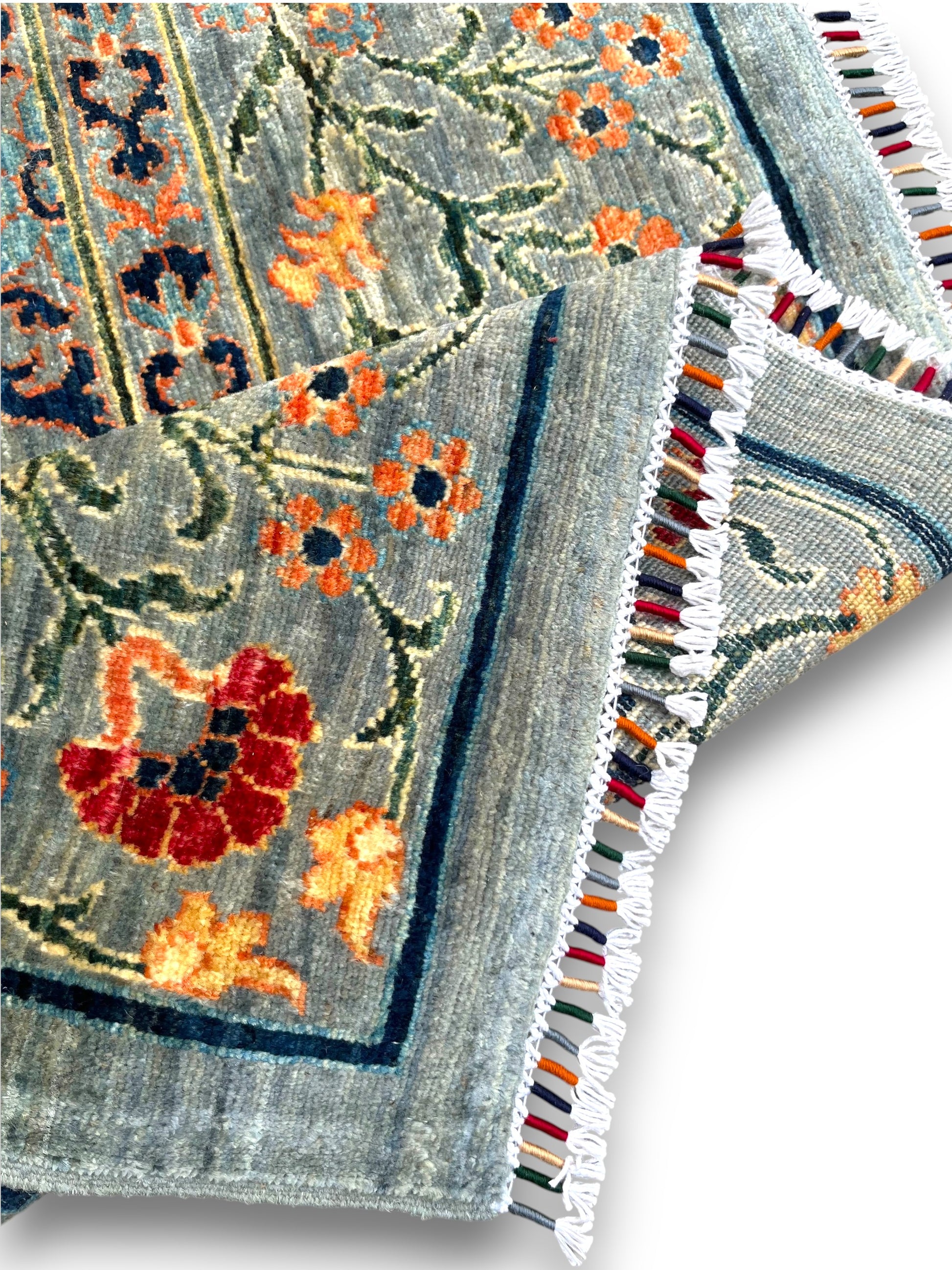 Close-up detail of circular ornament medallion showing intricate floral bouquet and golden rim design