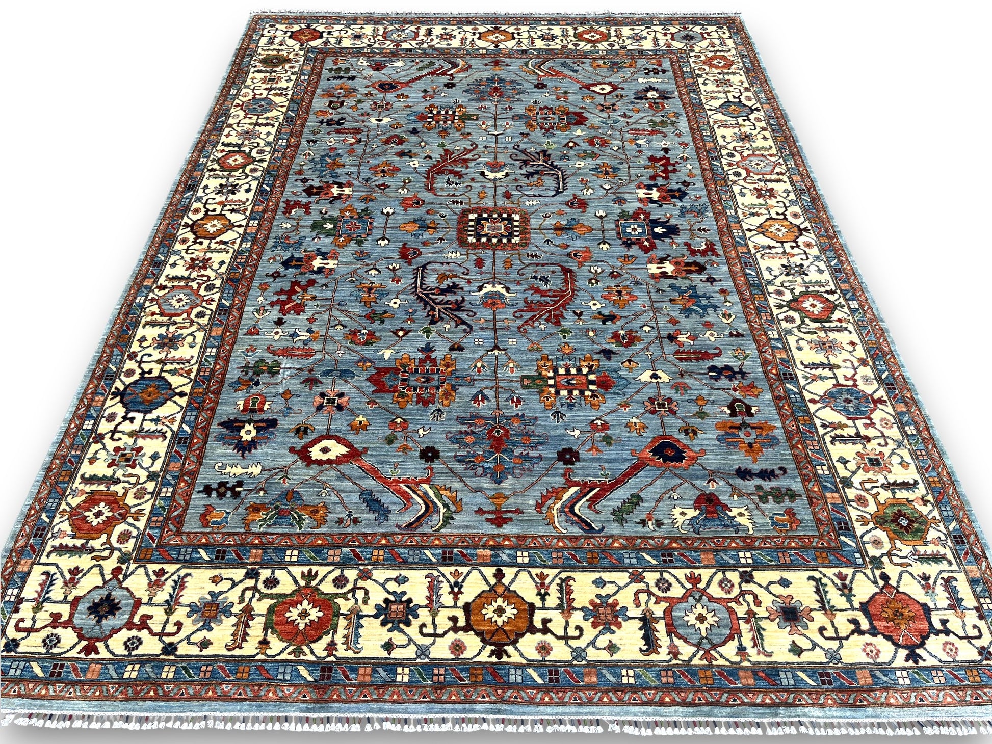 Large blue Afghan rosette rug displayed in elegant room setting showing oversized scale and design