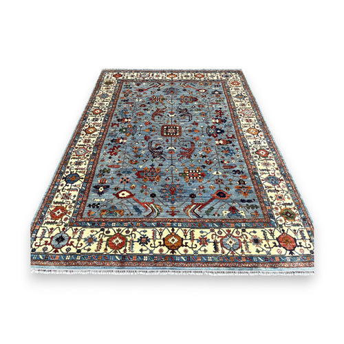 Blue Afghan rosette rug with central medallion design and ivory floral border on white background