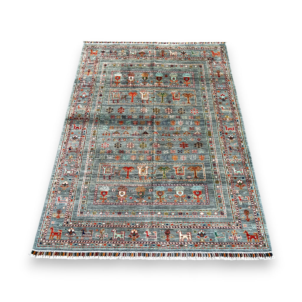 Close-up detail of Afghan hand-knotted wool rug showing intricate tribal motifs and natural wool texture