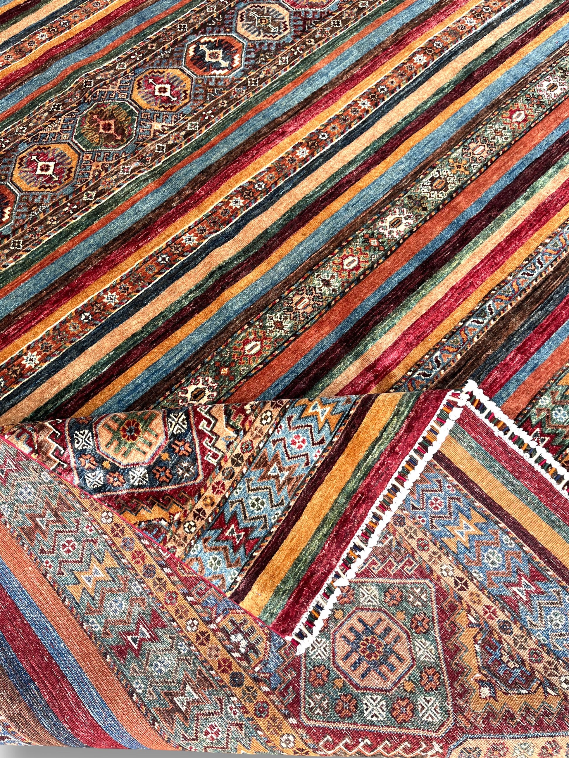 Detailed view of horizon rug fringe and color transitions between patterned and solid striped sections