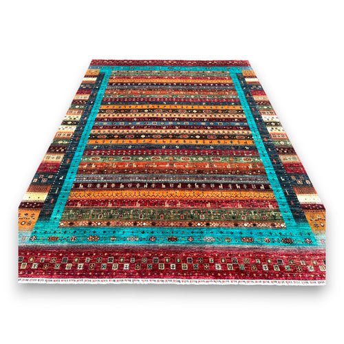 Afghan prism rug with vibrant turquoise border and multicolored striped bands on white background