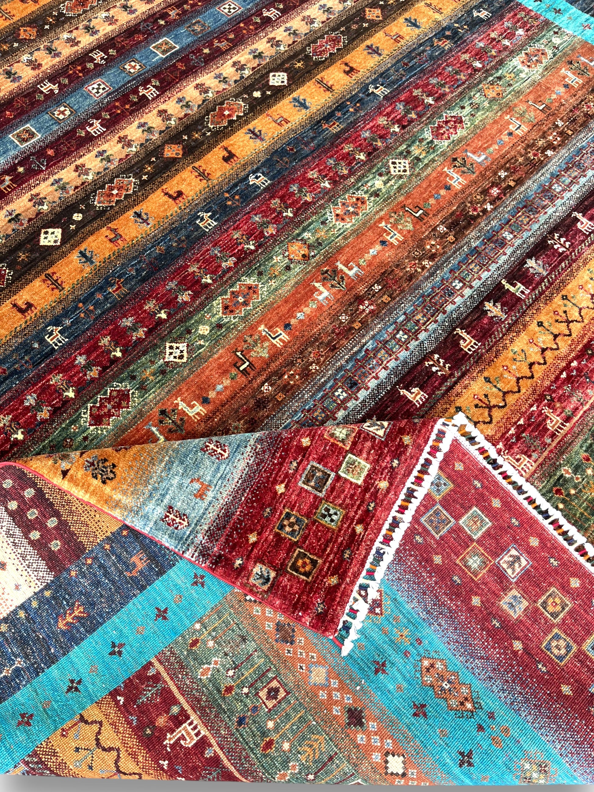 Detailed view of turquoise border and corner medallions with premium hand-knotted construction