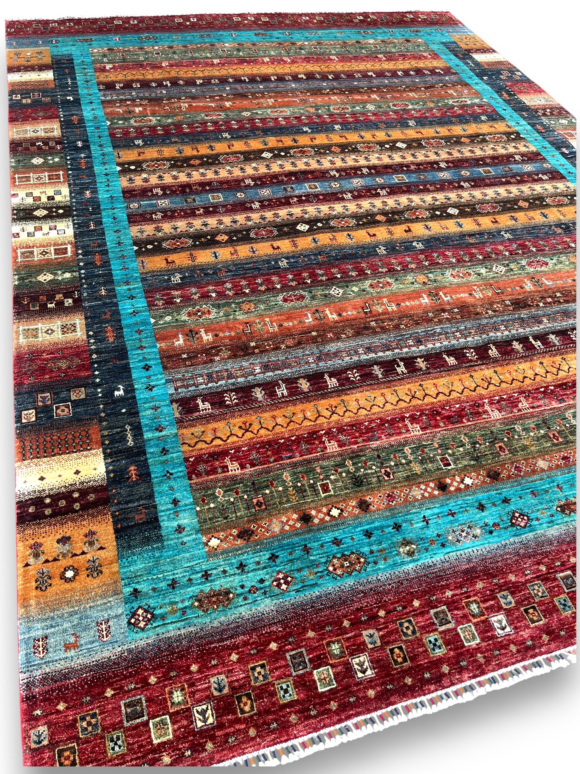 Close-up detail of prism rug showing geometric patterns and traditional motifs in colorful striped bands