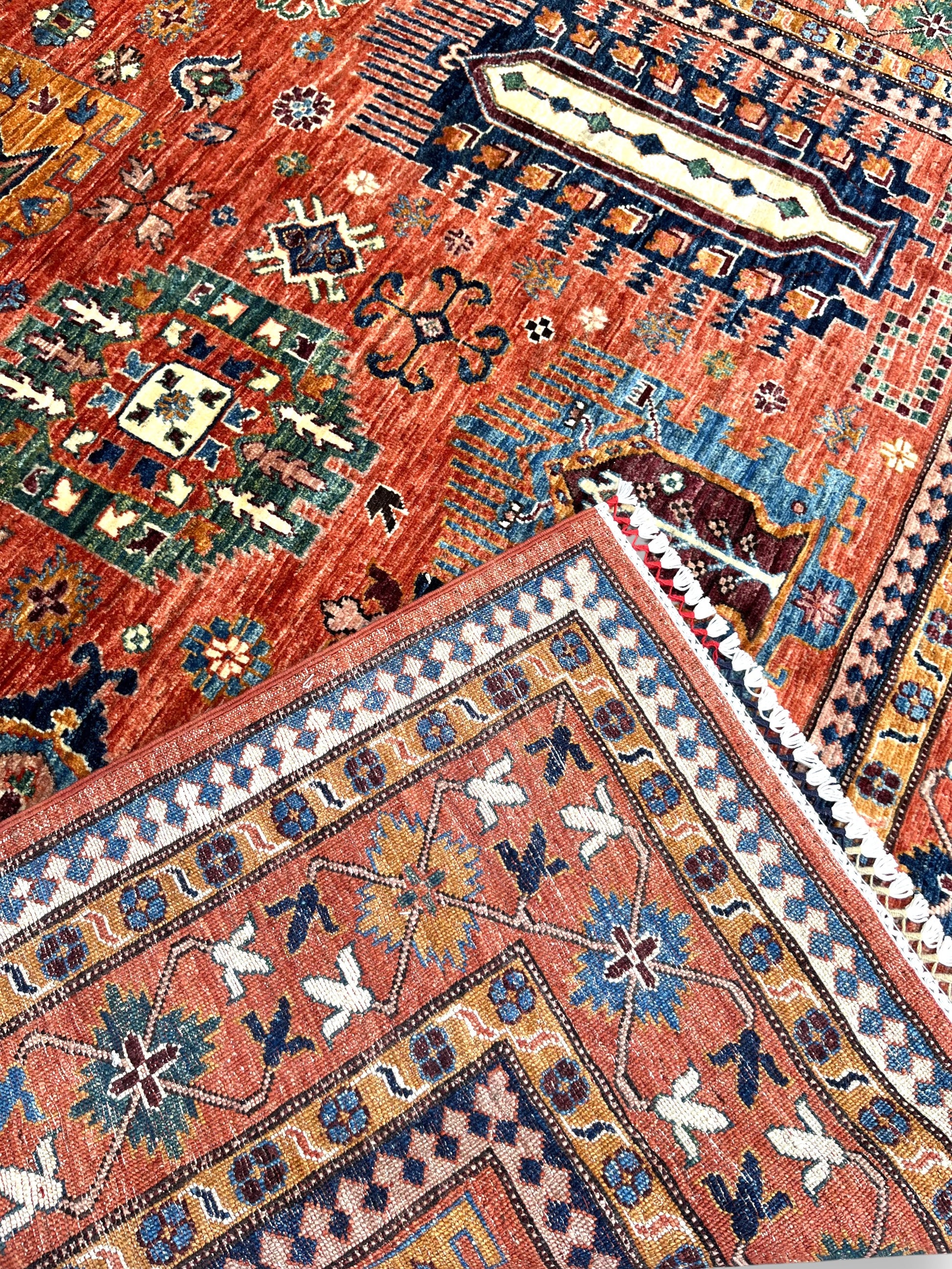 Detailed view of Afghan rug border featuring traditional geometric patterns and superior knot construction