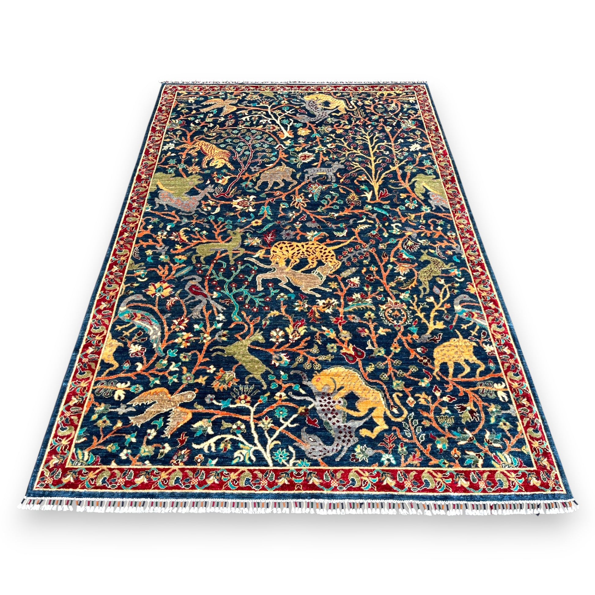 Navy blue Afghan hand-knotted wool rug 108x72 inches featuring golden lions, leopards, deer and exotic wildlife with red border on white background
